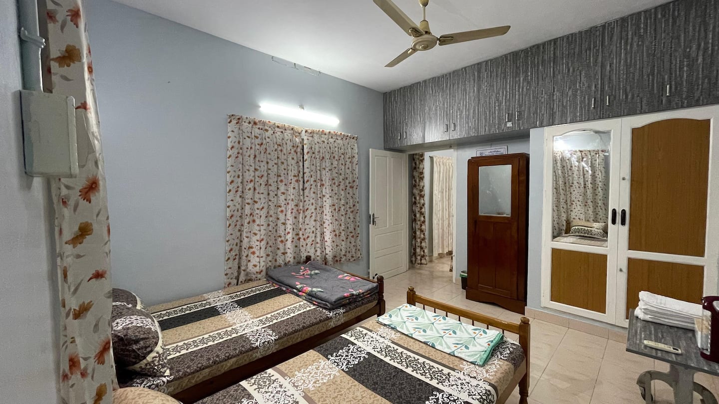 Bedroom with two beds and ceiling fan